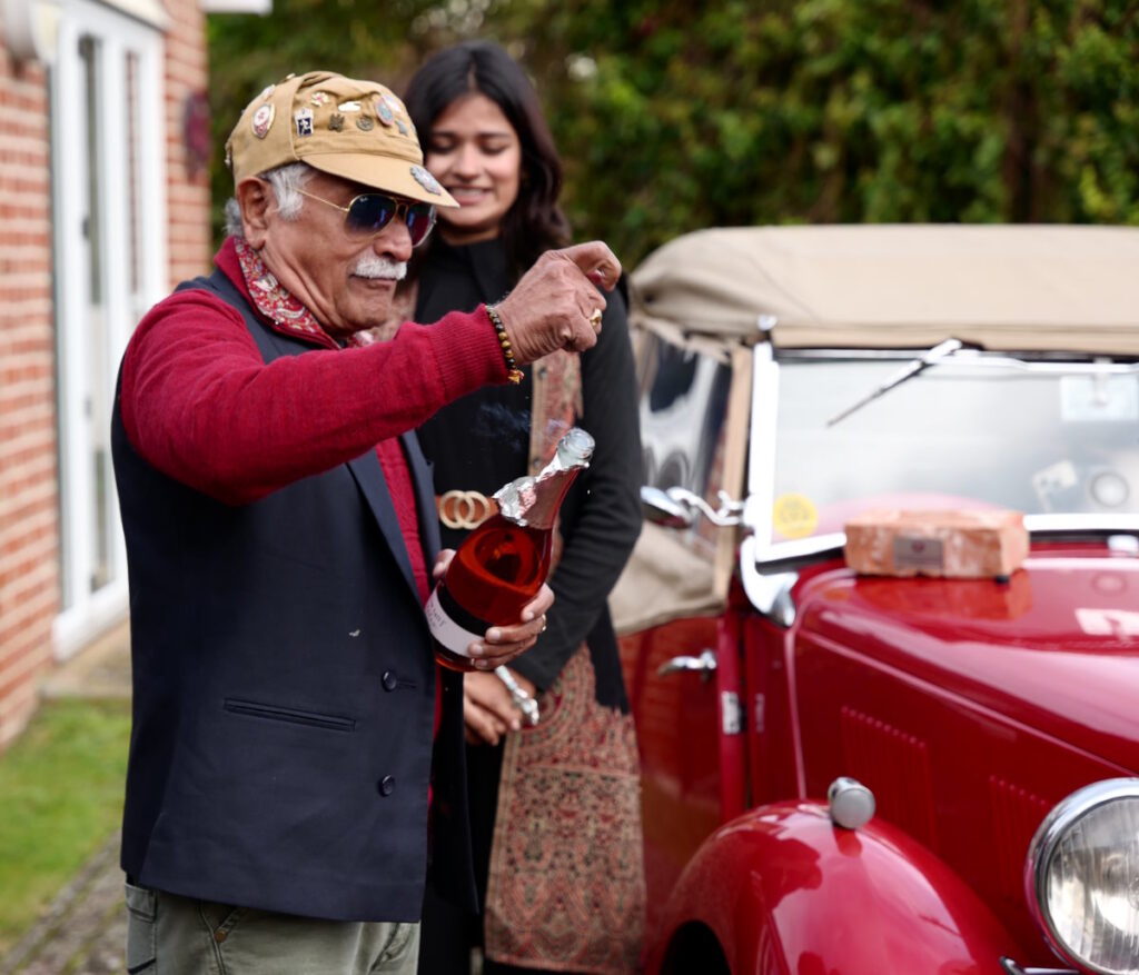 Damans father, Deval Thakore opening a bottle of bubbly to celebrate the Y Types return to Abingdon